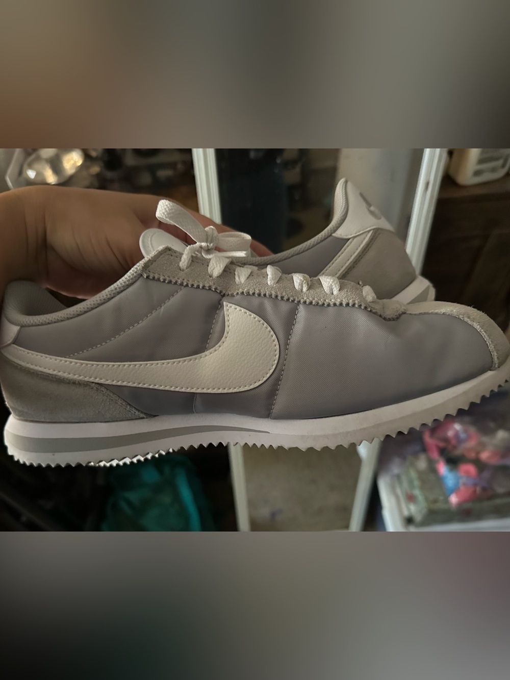 Woman’s gray Nike Cortez basic nylon
